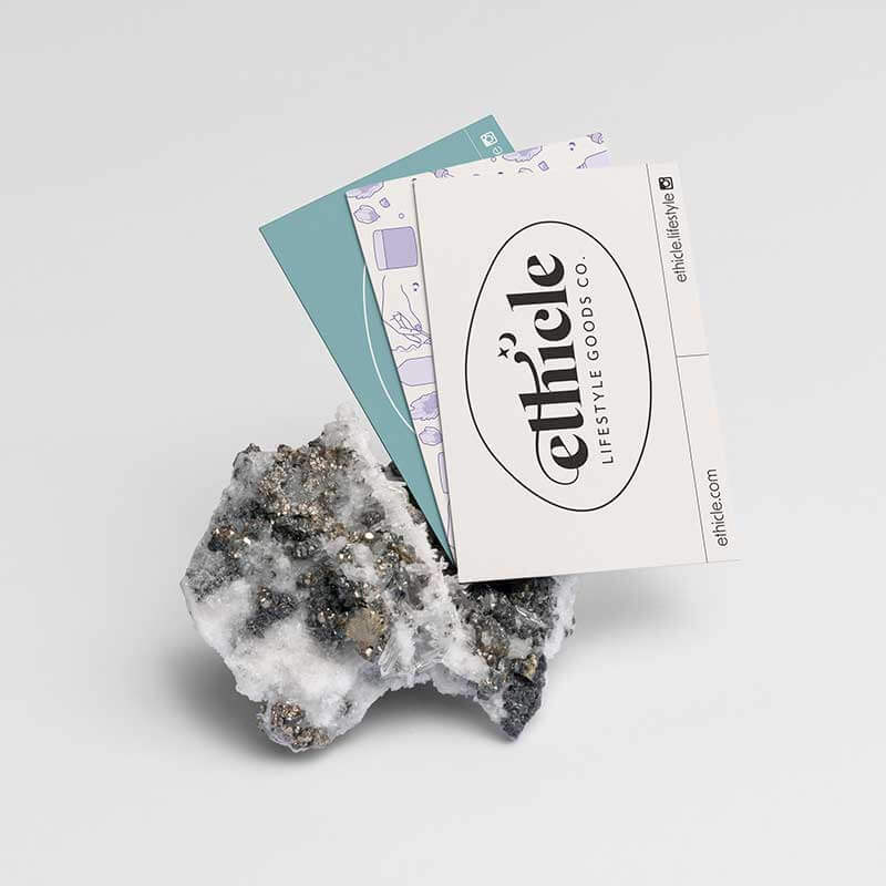 Mineral specimen with a branded card on a light gray background